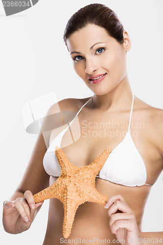 Image of Beautiful woman holding a starfish