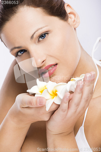 Image of Beautiful woman holding flowers