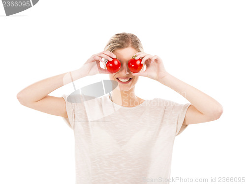 Image of Beaitiful woman with tomatos in front of the face