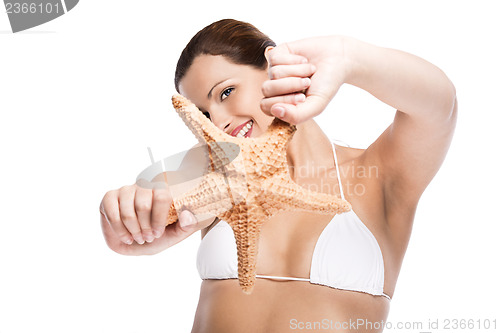 Image of Beautiful woman holding a starfish