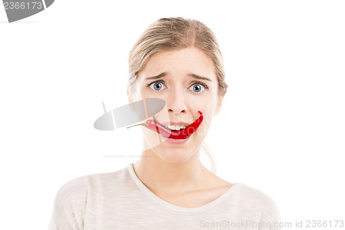 Image of Woman with a silly face holding a red chilli pepper