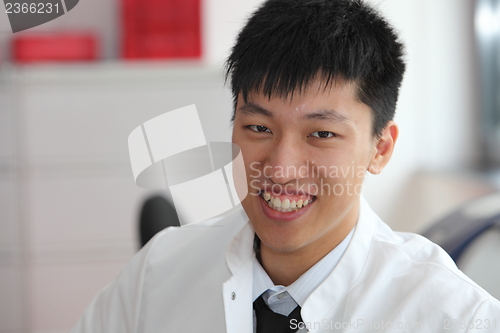 Image of Smiling Asian man in a lab coat