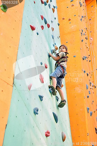 Image of child climbing up the wall