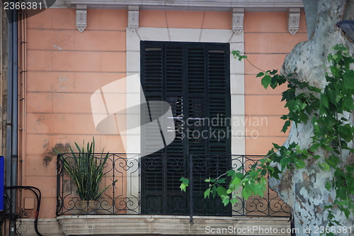 Image of Wooden door and wrought iron balcony