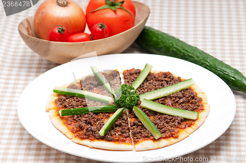 Image of Turkish beef pizza with cucumber on top