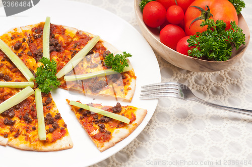 Image of Turkish beef pizza with cucumber on top