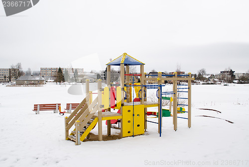 Image of colorful playground frozen snowy lake house winter 