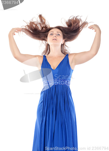 Image of Portrait of a beautiful young woman in blue dress with streaming