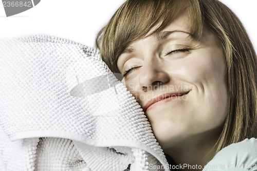 Image of Pretty girl cuddling in a towel