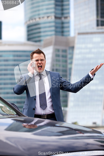 Image of businessman shouting into the phone