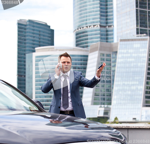 Image of Businessman near a car