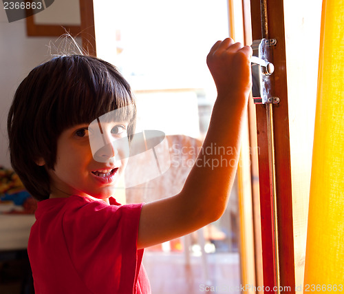 Image of boy opens the door of a new home