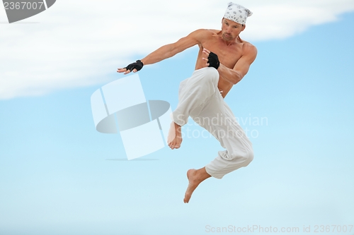 Image of man is jumping sport karate martial arts fight kick