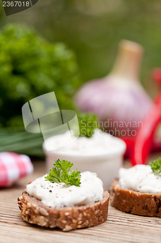 Image of fresh tasty homemade cream cheese and herbs with bread