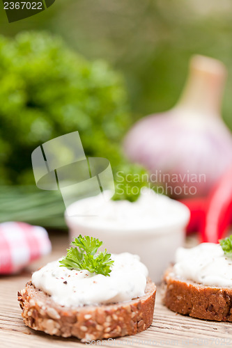 Image of fresh tasty homemade cream cheese and herbs with bread