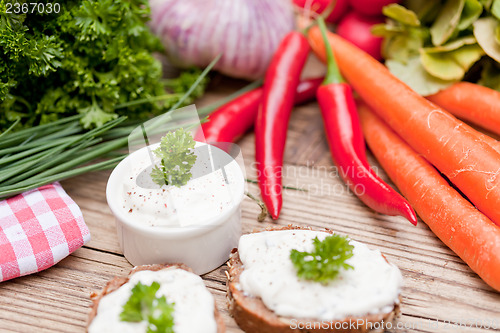 Image of fresh tasty homemade cream cheese and herbs with bread