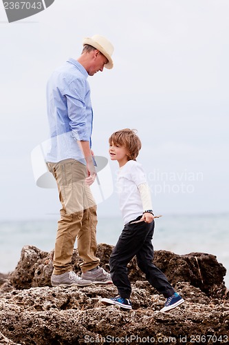 Image of father and son playing outdoor on beach summer vacation