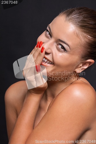 Image of beautiful young woman with orange lipstick and brown eyes 