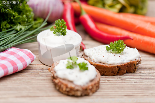 Image of fresh tasty homemade cream cheese and herbs with bread