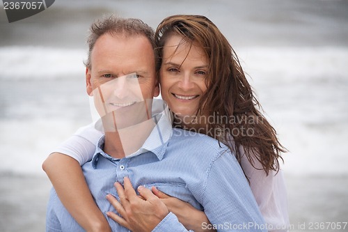 Image of happy adult couple in summertime on beach 