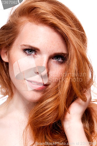 Image of beautiful young smiling woman with red hair and freckles isolated