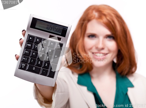 Image of attractive smiling redhead business woman with calculator isolated