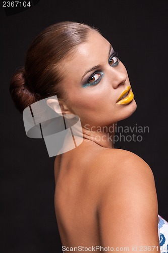 Image of woman with extreme colorfull make up in blue and yellow