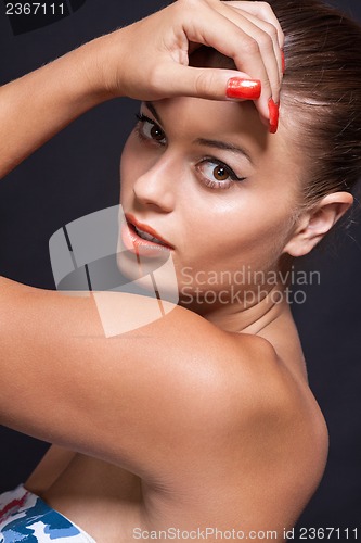 Image of beautiful young woman with orange lipstick and brown eyes 