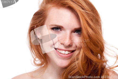 Image of beautiful young smiling woman with red hair and freckles isolated