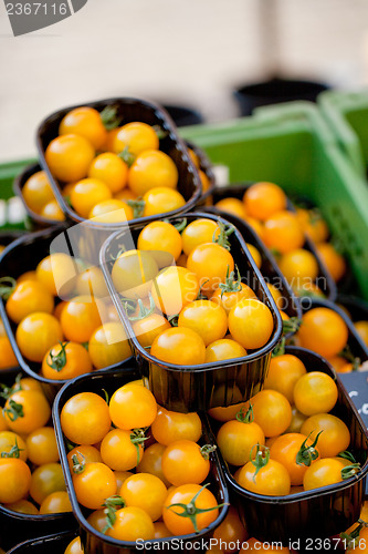 Image of fresh tasty yellow cherry tomatoes macro closeup on market