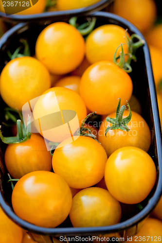 Image of fresh tasty yellow cherry tomatoes macro closeup on market