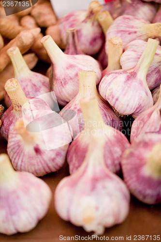 Image of group of purple white garlic in basket macro