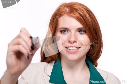 Image of attractive smiling business woman writing with pen isolated 