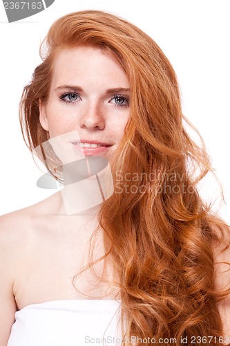 Image of beautiful young smiling woman with red hair and freckles isolated