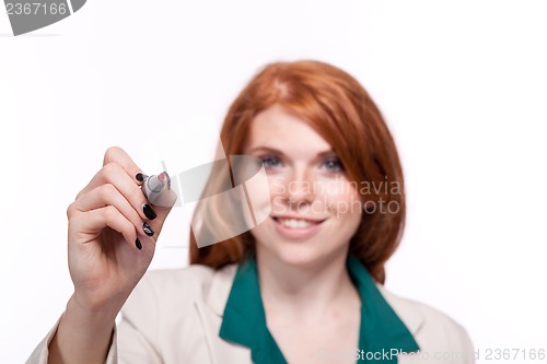 Image of attractive smiling business woman writing with pen isolated 