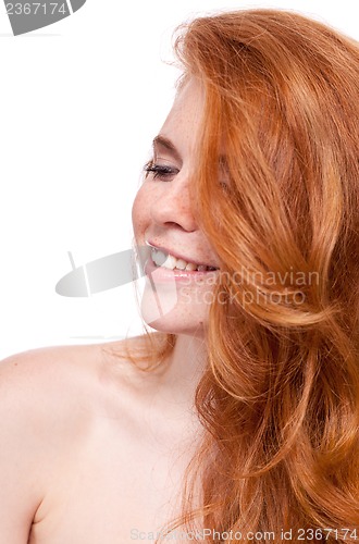 Image of beautiful young smiling woman with red hair and freckles isolated