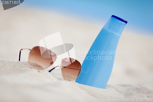 Image of sunprotection summer holiday sunglasses and cream