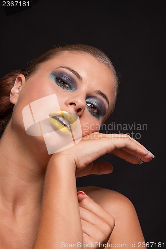 Image of woman with extreme colorfull make up in blue and yellow