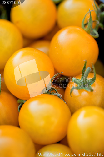 Image of fresh tasty yellow cherry tomatoes macro closeup on market
