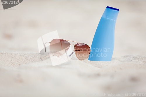 Image of sunprotection summer holiday sunglasses and cream