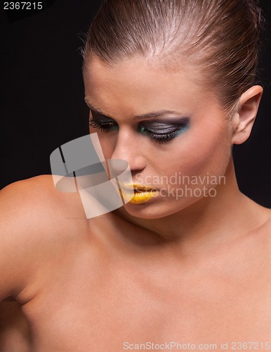 Image of woman with extreme colorfull make up in blue and yellow