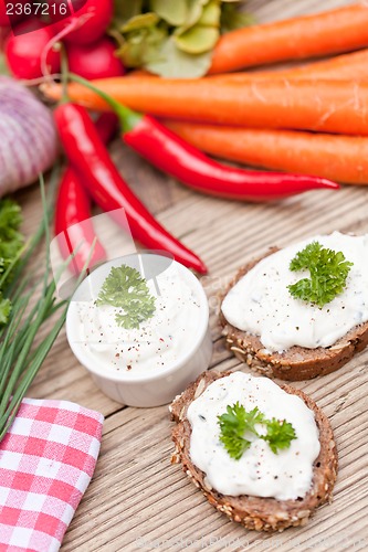 Image of fresh tasty homemade cream cheese and herbs with bread