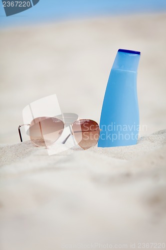 Image of sunprotection summer holiday sunglasses and cream