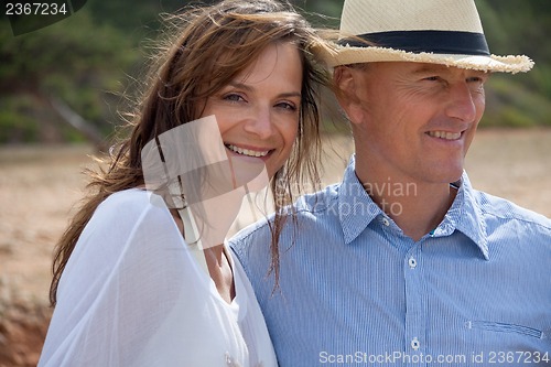 Image of happy adult couple in summertime on beach 