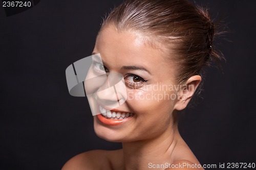 Image of beautiful young woman with orange lipstick and brown eyes 