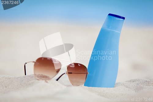 Image of sunprotection summer holiday sunglasses and cream