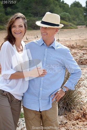 Image of happy adult couple in summertime on beach 