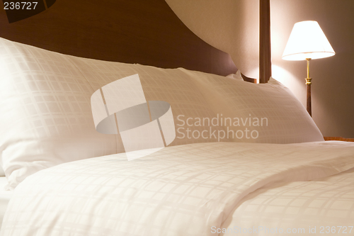 Image of King sized bed in a hotel suite room

