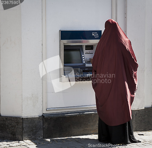 Image of Muslim lady by cashpoint