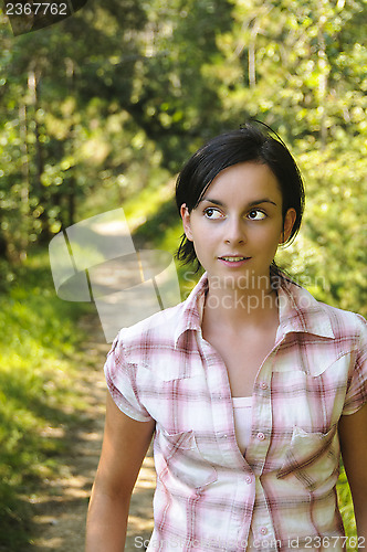 Image of Young Caucasian girl on a hiking path